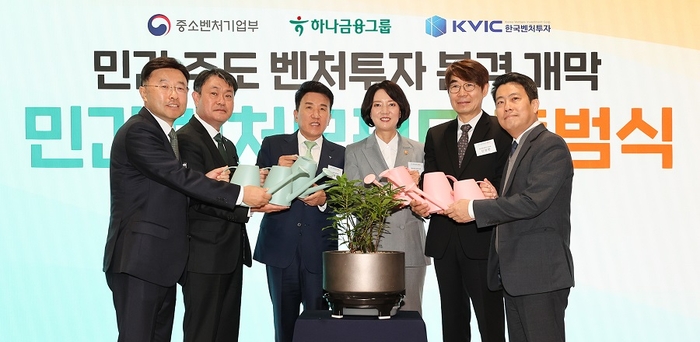 하나금융그룹은 서울 강남구 소재 서울창업허브 스케일업센터에서 제1호 민간 모펀드 출범식을 갖고 국내에서 민간이 중심이 되는 벤처 모펀드 시대의 본격 개막을 알렸다. 이영 중소벤처기업부 장관(왼쪽에서 네번째)과 함영주 하나금융그룹 회장(왼쪽에서 세번째), 성영수 하나은행 부행장(사진 왼쪽에서 두번째), 안선종 하나벤처스 사장(사진 왼쪽에서 첫번째), 신상한 한국벤처투자 부대표(왼쪽에서 다섯번째), 임정욱 중소벤처기업부 창업벤처혁신실장(왼쪽에서 여섯번째)이 민간 중심의 벤처생태계 전환의 마중물을 마련한다는 의미의 '마중물 세레모니'를 하며 기념촬영을 하고 있다. 사진=하나은행
